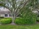 Backyard view featuring a large tree and green space at 604 Masterpiece Dr # 604, Sun City Center, FL 33573