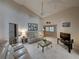 Bright living room featuring vaulted ceilings, neutral color palette, and comfortable seating at 604 Masterpiece Dr # 604, Sun City Center, FL 33573