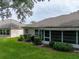 Home's backyard features a large grassy area and screened patio at 604 Masterpiece Dr # 604, Sun City Center, FL 33573