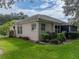 Single-story home with screened patio and well-manicured lawn at 604 Masterpiece Dr # 604, Sun City Center, FL 33573