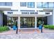 Attractive building entrance with glass doors and landscaping at 707 S Gulfstream Ave # 602, Sarasota, FL 34236
