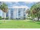 Modern high-rise building with lush landscaping and ample parking at 707 S Gulfstream Ave # 602, Sarasota, FL 34236