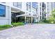 Essex House entrance with paved pathway, lush landscaping, and building signage at 707 S Gulfstream Ave # 602, Sarasota, FL 34236