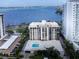 Aerial view of condo building with pool and water views at 707 S Gulfstream Ave # 602, Sarasota, FL 34236