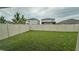 Large backyard with grassy area and privacy fence at 34220 Jasper Stone Dr, Wesley Chapel, FL 33543