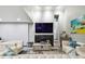 Living room with white couches, a stone fireplace, and large TV at 240 Windward Psge # 605, Clearwater Beach, FL 33767