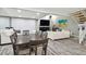 Open concept dining area with a large table and adjacent living room at 240 Windward Psge # 605, Clearwater Beach, FL 33767