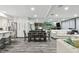 Open concept kitchen, dining, and living area with white cabinets and flooring at 240 Windward Psge # 605, Clearwater Beach, FL 33767