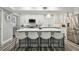 Modern kitchen with island, white cabinets, and stainless steel appliances at 240 Windward Psge # 605, Clearwater Beach, FL 33767