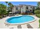 Inviting kidney-shaped pool with lounge chairs at 240 Windward Psge # 605, Clearwater Beach, FL 33767