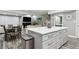 Modern kitchen island with white cabinets and quartz countertop at 240 Windward Psge # 605, Clearwater Beach, FL 33767