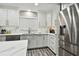 Modern kitchen with white cabinets, quartz countertops and stainless steel appliances at 240 Windward Psge # 605, Clearwater Beach, FL 33767