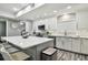 Modern kitchen with island, white cabinets, and stainless steel appliances at 240 Windward Psge # 605, Clearwater Beach, FL 33767