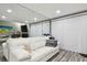 Living room with white couch, gray walls, and vertical blinds at 240 Windward Psge # 605, Clearwater Beach, FL 33767