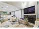 Living room with white couches, a large TV, and a stone fireplace at 240 Windward Psge # 605, Clearwater Beach, FL 33767