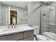 Modern bathroom with gray tile, a walk-in shower, and white countertop at 240 Windward Psge # 605, Clearwater Beach, FL 33767