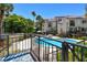 Community pool with lounge chairs and lush landscaping at 240 Windward Psge # 605, Clearwater Beach, FL 33767