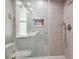 Bathroom with a tiled shower and built-in storage at 240 Windward Psge # 605, Clearwater Beach, FL 33767