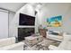 Living room with white couches, a stone fireplace, and large TV at 240 Windward Psge # 605, Clearwater Beach, FL 33767