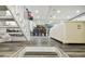 View of stairs leading down into a living area with white couches at 240 Windward Psge # 605, Clearwater Beach, FL 33767