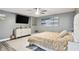Main bedroom with large bed, dresser, and wall-mounted TV at 240 Windward Psge # 605, Clearwater Beach, FL 33767