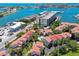 Aerial showcasing community near waterfront, with multiple buildings and boat slips at 240 Windward Psge # 605, Clearwater Beach, FL 33767