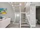 Modern staircase with white railings and gray wood-look flooring at 240 Windward Psge # 605, Clearwater Beach, FL 33767