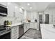Modern kitchen with stainless steel appliances and white shaker cabinets at 240 Windward Psge # 605, Clearwater Beach, FL 33767