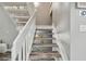 White staircase leading to the upper level at 240 Windward Psge # 605, Clearwater Beach, FL 33767