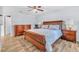 Bright bedroom featuring a large bed and wood floors at 1129 Danny Dr, Sarasota, FL 34243