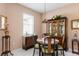 Charming dining room with a round table, wooden hutch and window lighting at 2078 Sifield Greens Way # 05, Sun City Center, FL 33573