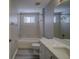 Bathroom with a bathtub, a toilet, and a vanity with white marble countertop at 19334 Autumn Woods Ave, Tampa, FL 33647