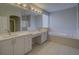 Bright bathroom showcasing double sinks, vanity space, walk-in shower and a soaking tub at 19334 Autumn Woods Ave, Tampa, FL 33647
