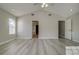 Spacious bedroom with gray wood floors, vaulted ceiling, and two doorways with open doors at 19334 Autumn Woods Ave, Tampa, FL 33647