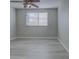 Bedroom with laminate floors, neutral walls, ceiling fan and a window with blinds at 19334 Autumn Woods Ave, Tampa, FL 33647