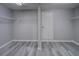 Large walk-in closet with wire shelving, gray walls, and wood-look floors at 19334 Autumn Woods Ave, Tampa, FL 33647
