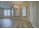 Bright dining room with wood-look floors, modern chandelier, and a door to the outside at 19334 Autumn Woods Ave, Tampa, FL 33647