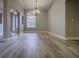 Bright dining room boasts wood-style floors, elegant chandelier, large arched window, and neutral wall paint at 19334 Autumn Woods Ave, Tampa, FL 33647