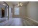 Bright dining room boasts wood-style floors, elegant chandelier, large arched window, and neutral wall paint at 19334 Autumn Woods Ave, Tampa, FL 33647