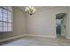Empty dining room with chandelier, a large window, and hardwood floors at 19334 Autumn Woods Ave, Tampa, FL 33647