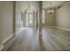 Elegant foyer featuring gray-toned laminate flooring and arched doorways at 19334 Autumn Woods Ave, Tampa, FL 33647