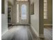 Front door opens to foyer with sidelight window and luxury vinyl plank flooring at 19334 Autumn Woods Ave, Tampa, FL 33647