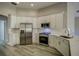 Bright kitchen featuring white cabinetry, stainless steel appliances, and hardwood floors at 19334 Autumn Woods Ave, Tampa, FL 33647