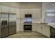 Bright kitchen featuring white cabinetry, stainless steel appliances, and hardwood floors at 19334 Autumn Woods Ave, Tampa, FL 33647