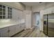 Bright kitchen featuring white cabinetry, stainless steel appliances, and hardwood floors at 19334 Autumn Woods Ave, Tampa, FL 33647