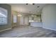 Open-concept living space with wood-look floors, recessed lighting, and kitchen bar at 19334 Autumn Woods Ave, Tampa, FL 33647