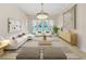 Cozy living room with neutral decor, complemented by a chandelier and backyard view at 19334 Autumn Woods Ave, Tampa, FL 33647