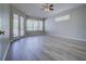 Bright living room featuring gray walls, neutral flooring, and large windows that provide ample natural light at 19334 Autumn Woods Ave, Tampa, FL 33647
