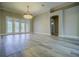 Bright living room featuring hardwood floors, neutral walls, and a modern light fixture at 19334 Autumn Woods Ave, Tampa, FL 33647