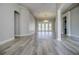 Bright living room featuring hardwood floors, neutral walls, and a modern light fixture at 19334 Autumn Woods Ave, Tampa, FL 33647
